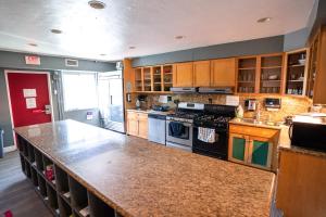 a large kitchen with a large counter top in it at California Dreams Hostel - Ocean Beach in San Diego