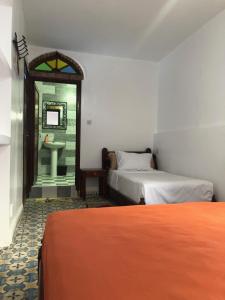 Ένα ή περισσότερα κρεβάτια σε δωμάτιο στο Hotel Nisrine