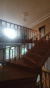 a staircase in a house with the sun shining through the window at Дом в Хырдалане in Xirdalan