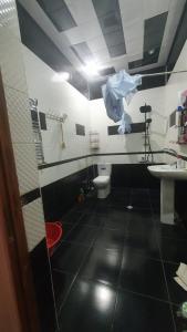 a bathroom with a white toilet and a sink at Дом в Хырдалане in Xirdalan