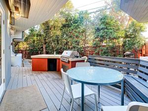 an outdoor kitchen with a table and chairs on a deck at Venice Beach Delight in Los Angeles