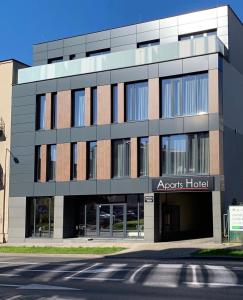an apartment building with aagent hospital sign in front of a street at Aparts Hotel Radom in Radom
