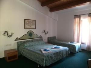 Giường trong phòng chung tại Locanda Michelacci