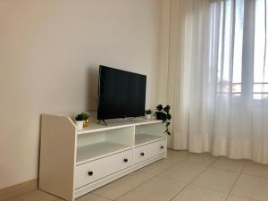 a white entertainment center with a flat screen tv on it at Marco Polo Apartment in Milan