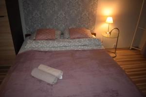 a large bed in a bedroom with a pink blanket at Apartament M-5 in Częstochowa