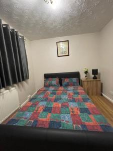 a bedroom with a bed with a colorful quilt at 182 in Drayton