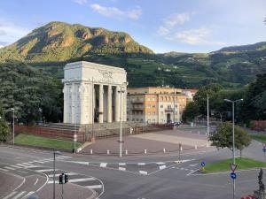 a large building with a mountain in the background at CASA VITTORIA - SIEGESHAUS in Bolzano