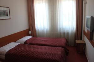 Posteľ alebo postele v izbe v ubytovaní Hotel Dominika