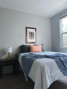 a bedroom with a bed with a blue blanket at Sleepover 1BD 1BA Omaha Apartments in Omaha