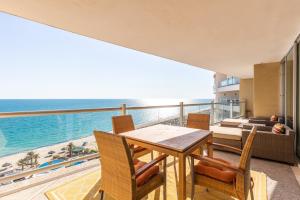a dining room with a view of the ocean at Encanto Living 1104 by Kivoya in Puerto Peñasco