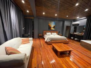 a bedroom with a bed and a couch and a table at Patio del Puerto Hotel Boutique in Puerto Rico +140 photos