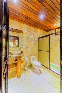 a bathroom with a toilet and a sink at Casa Shaquir H - Coastal Bliss Oasis in Puerto Viejo