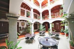 a courtyard with tables and chairs in a building at Hotel Casa de la Tía Tere in Oaxaca City
