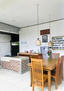 a dining room with a table and chairs and a kitchen at Putu Homestay in Canggu +24 photos