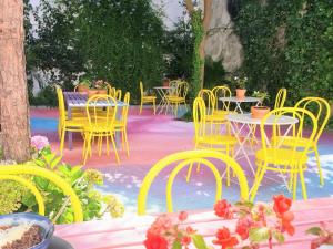 a patio area with tables, chairs and umbrellas at SUPERNOVA - Hostel & Café in Porto