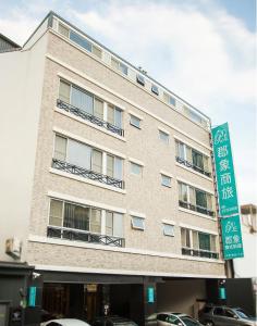 a building with a street sign in front of it at P&E Hotel in Tainan