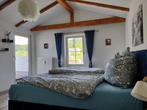 a bedroom with a blue couch and a window at Crampas 2 in Sassnitz