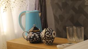 a table with two vases sitting on a shelf at Samarkand Сity Guest House in Samarkand