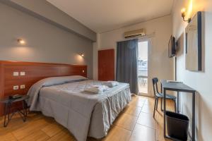 a bedroom with a bed and a large window at Stalis Hotel in Athens