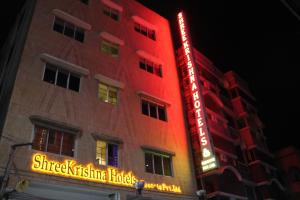 a building with a red neon sign on it at Shreekrishna Hotels & Resorts Pvt Ltd in Kolkata