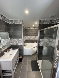 a bathroom with a tub and a shower and a sink at Domaine d'Aveluy in Aveluy +14 photos