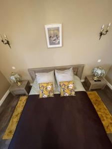 a bedroom with a large bed with two night stands at Domaine d'Aveluy in Aveluy