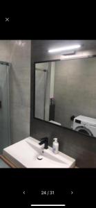a bathroom with a sink and a mirror at Apartament Silence Baltic Skandynawski in Pobierowo
