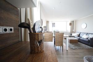 a living room with a couch and a table with chairs at Haus Uthlande Uthlande Whg 49 Inselauszeit in Wyk auf Föhr
