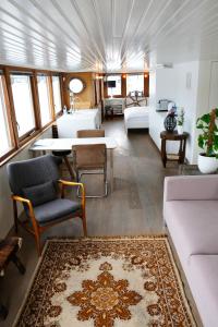 
a living room filled with furniture and a large window at Stunning boat with a view in Amsterdam
