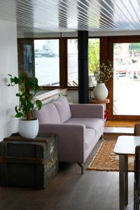 
a living room filled with furniture and a window at Stunning boat with a view in Amsterdam
