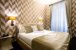 Posteľ alebo postele v izbe v ubytovaní Via Veneto Suites