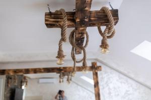 a wooden cross with ropes hanging from a ceiling at Rustic Luxury Apartment - Valjevo centre BID Zone in Valjevo