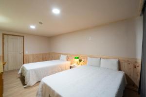 Postel nebo postele na pokoji v ubytování New Jeju Hotel
