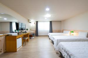 Postel nebo postele na pokoji v ubytování New Jeju Hotel + 24 fotografií