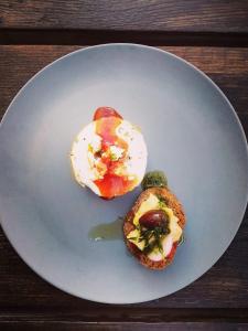a white plate with two food items on it at Areos Polis Boutique Hotel in Areopoli