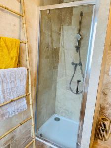 a shower with a glass door in a bathroom at Almanarre in Hyères