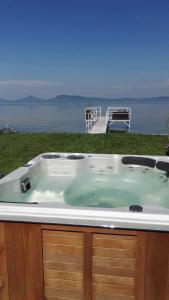 a hot tub with a view of the water at The Lake House in Fonyód