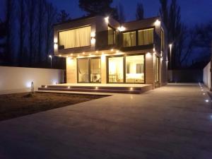a house with lights on it at night at The Lake House in Fonyód