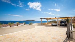 an outdoor patio with a view of the ocean at Apartment MORE Island Vis in Vis