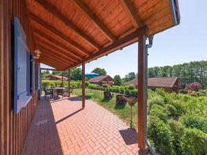 an outdoor patio with a wooden pergola at Haus Himmelblau am Jabeler See in Jabel