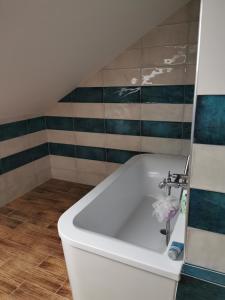 a white bath tub with a faucet in a bathroom at Ferienhaus mit Kamin in Krackow +11 photos