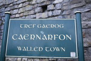 a sign in front of a brick wall at Bank Quay, Caernarfon in Caernarfon