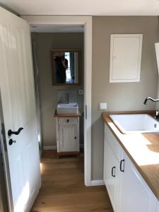 a person taking a picture of a bathroom with a sink at Tiny-House Reinsdorf in Apelern