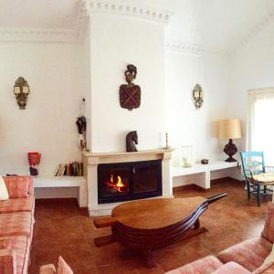 a living room with a fireplace and a couch at Finca las Encinas in Ronda