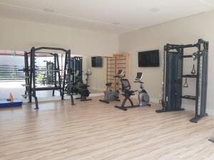a gym with several tread machines in a room at FLAT NA PRINCIPAL DE PIPA in Pipa