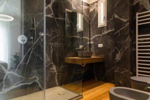 W łazience znajduje się prysznic ze szklanymi drzwiami. w obiekcie cefalù luxury appartament jacuzzi w Cefalù