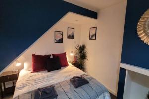 a bedroom with a large bed with red pillows at Modern and Spacious 4 Bedroom House, Hot Tub, Wifi, Netflix, Parking in Paignton