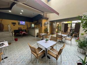 a restaurant with tables and chairs in a room at BELUX HOTEL in Tirana