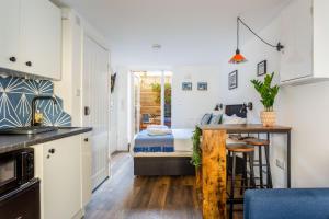 a kitchen with a sink and a bed in a room at Brighton Laines Apartments - Central Laines Location in Brighton & Hove