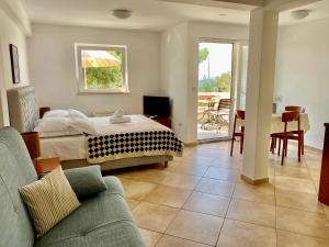 a bedroom with a bed and a living room at Apartments Villa Medic in Brela +109 photos